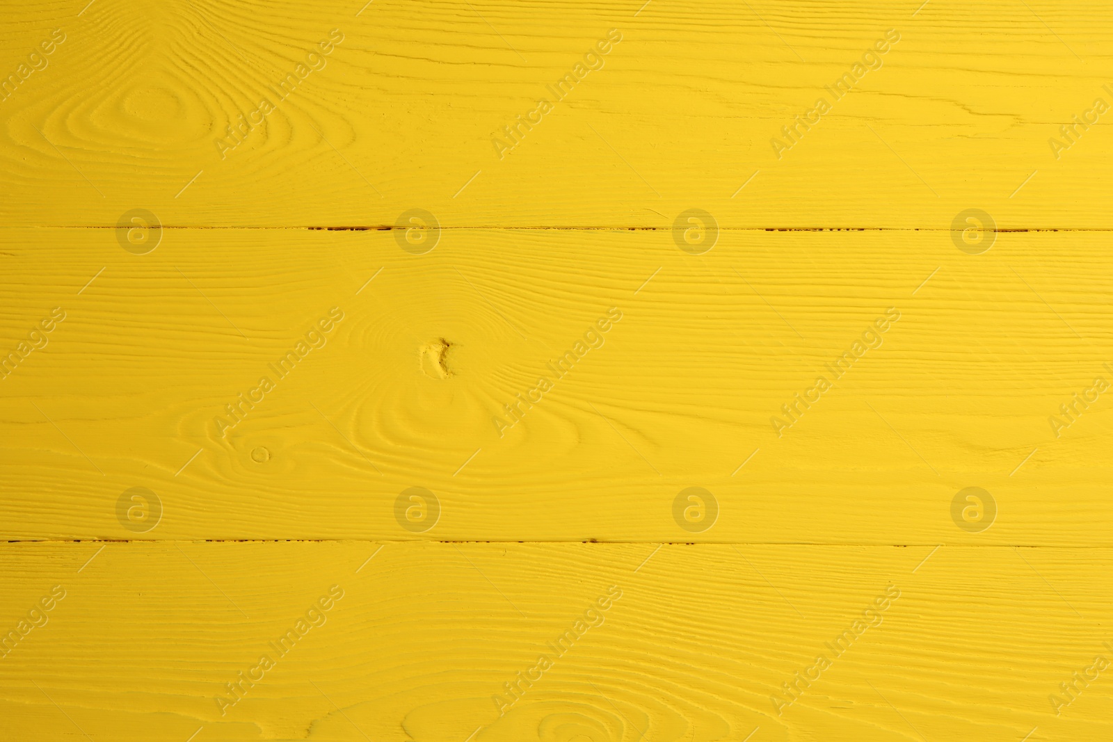 Photo of Texture of yellow wooden surface as background, closeup