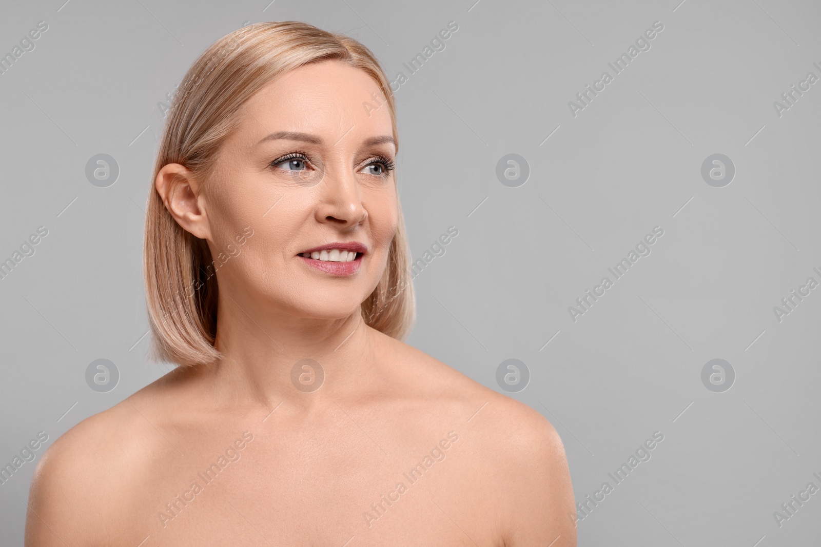 Photo of Beautiful woman with healthy skin on grey background