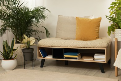 Photo of Stylish room interior with beautiful houseplants and comfortable bench