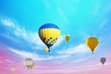 Image of Fantastic dreams. Hot air balloons in bright sky with clouds  