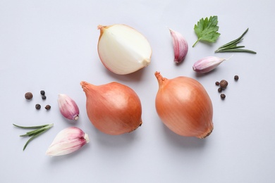 Photo of Flat lay composition with onions and spices on light background