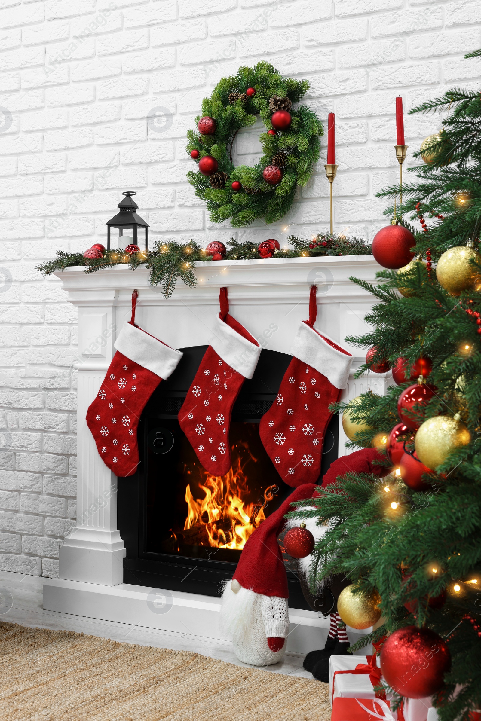 Photo of Cosy room with tree and fireplace decorated for Christmas. Interior design