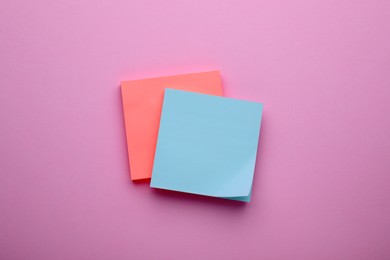 Photo of Paper notes on pale pink background, top view