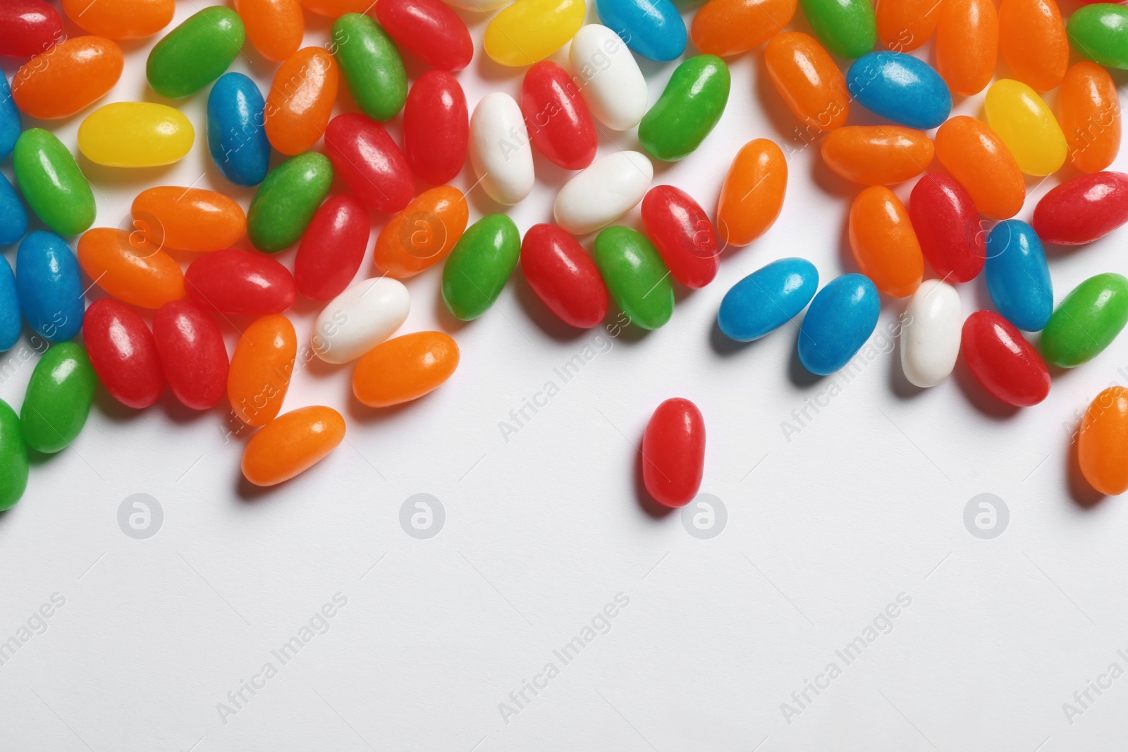 Photo of Colorful jelly candies on white background, top view