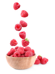 Image of Fresh ripe tasty raspberries falling into bowl on white background