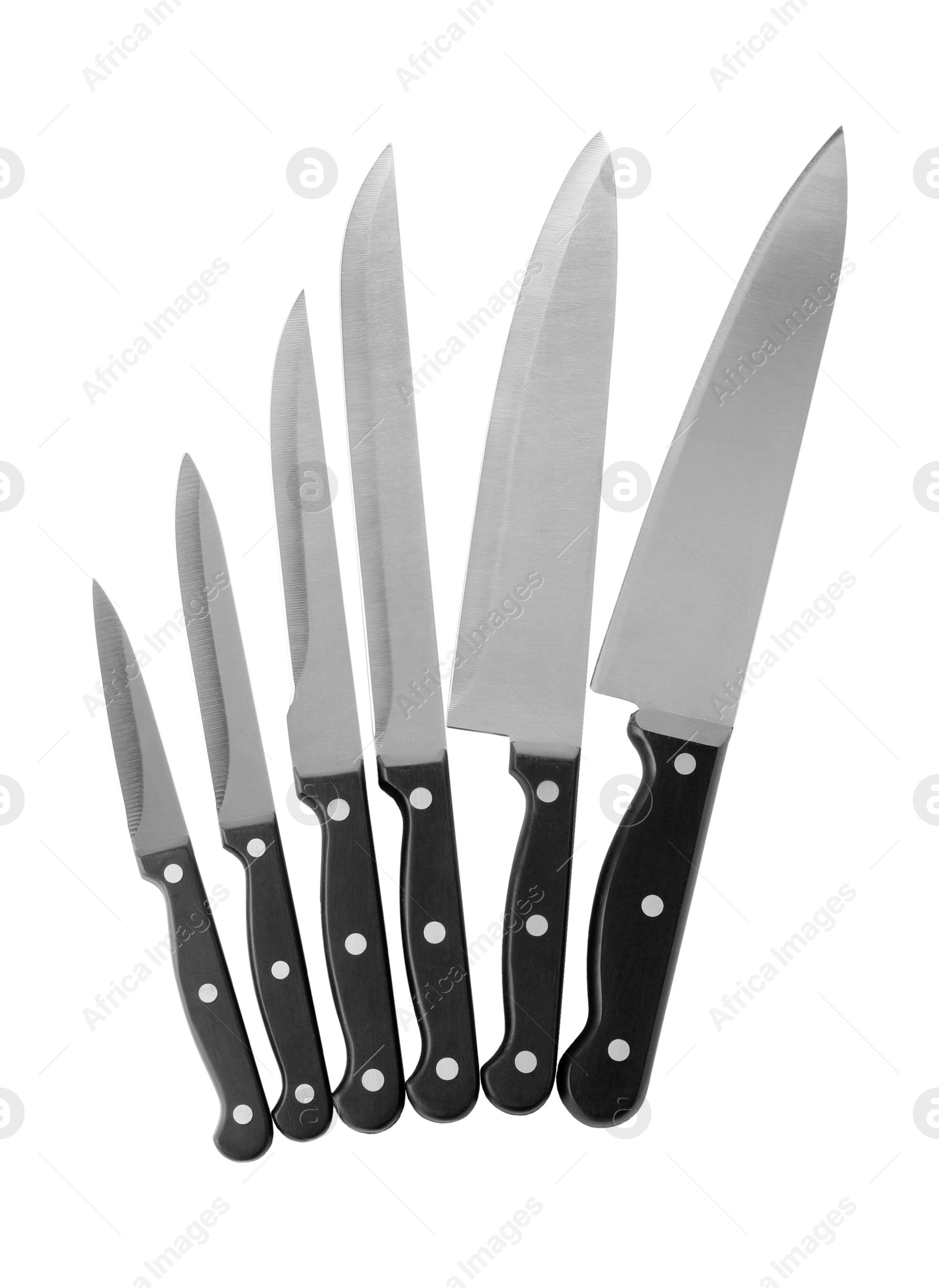 Photo of Set of sharp knives on white background, top view