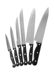 Set of sharp knives on white background, top view