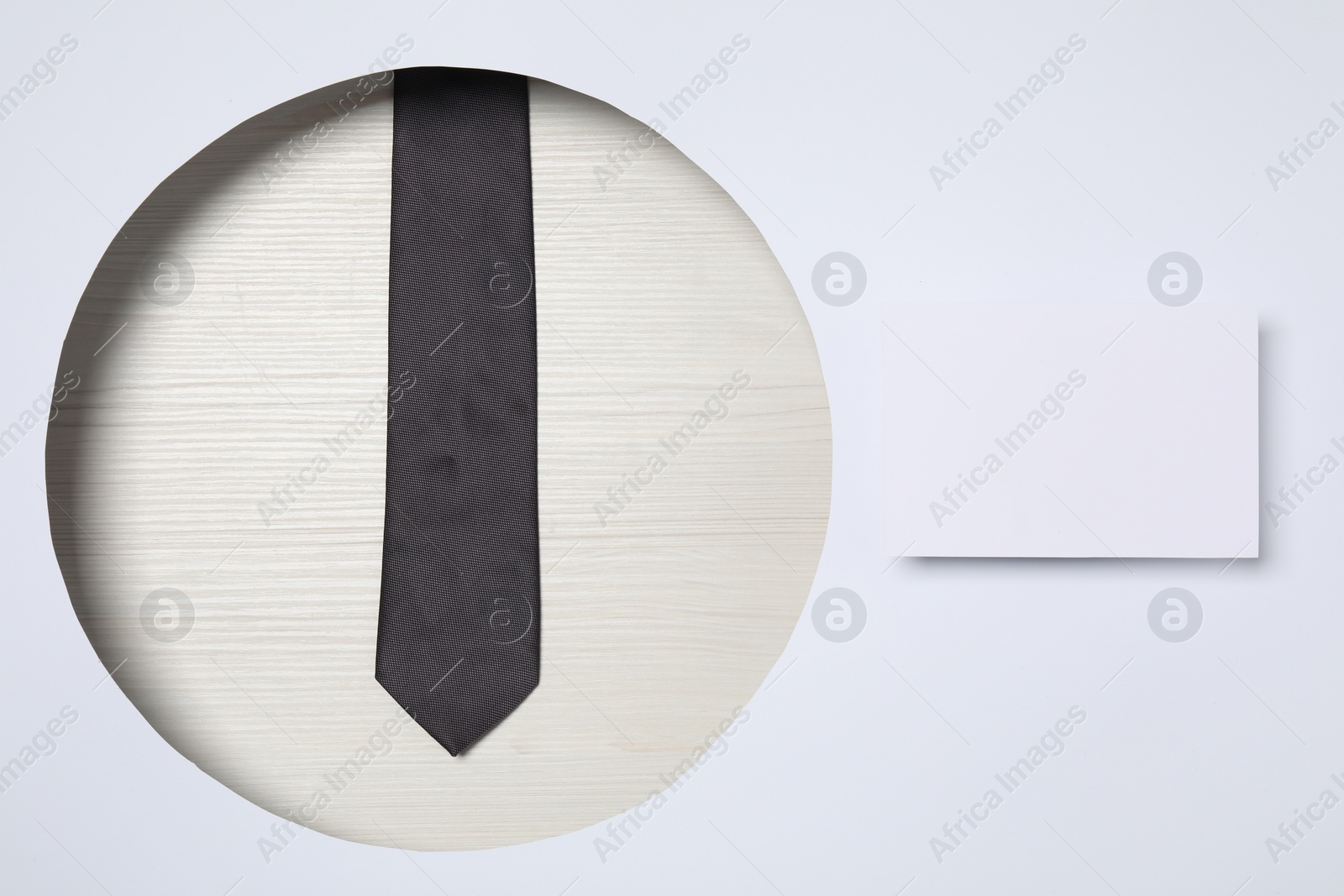 Photo of Creative business lunch layout. Composition with tie, and blank card on white background
