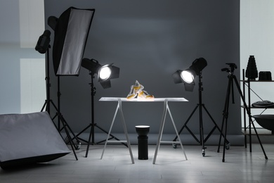 Photo of Professional photography equipment prepared for shooting stylish shoes in studio