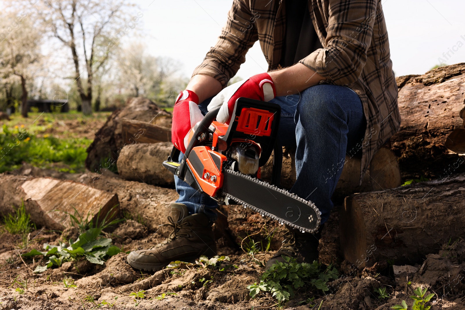 Photo of Man with modern saw outdoors, closeup view