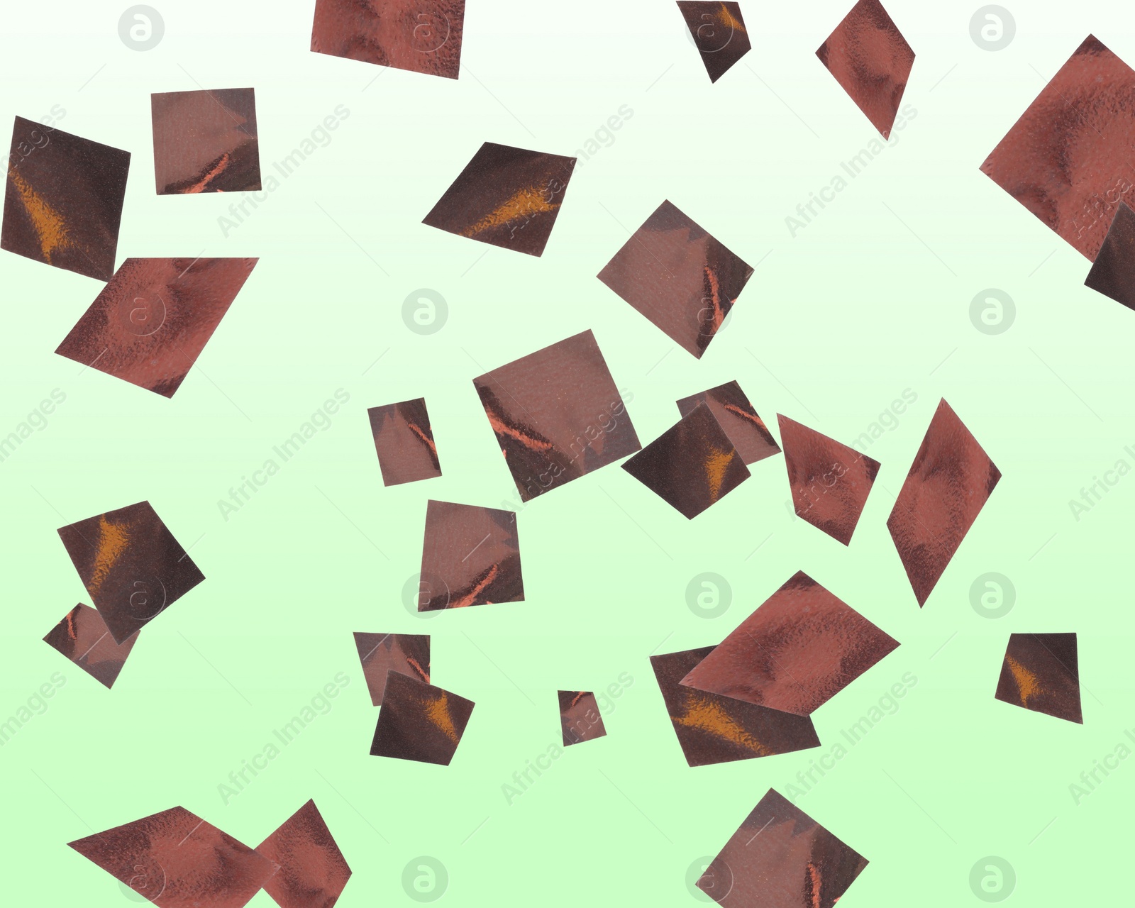 Image of Shiny bronze confetti falling on gradient light green background