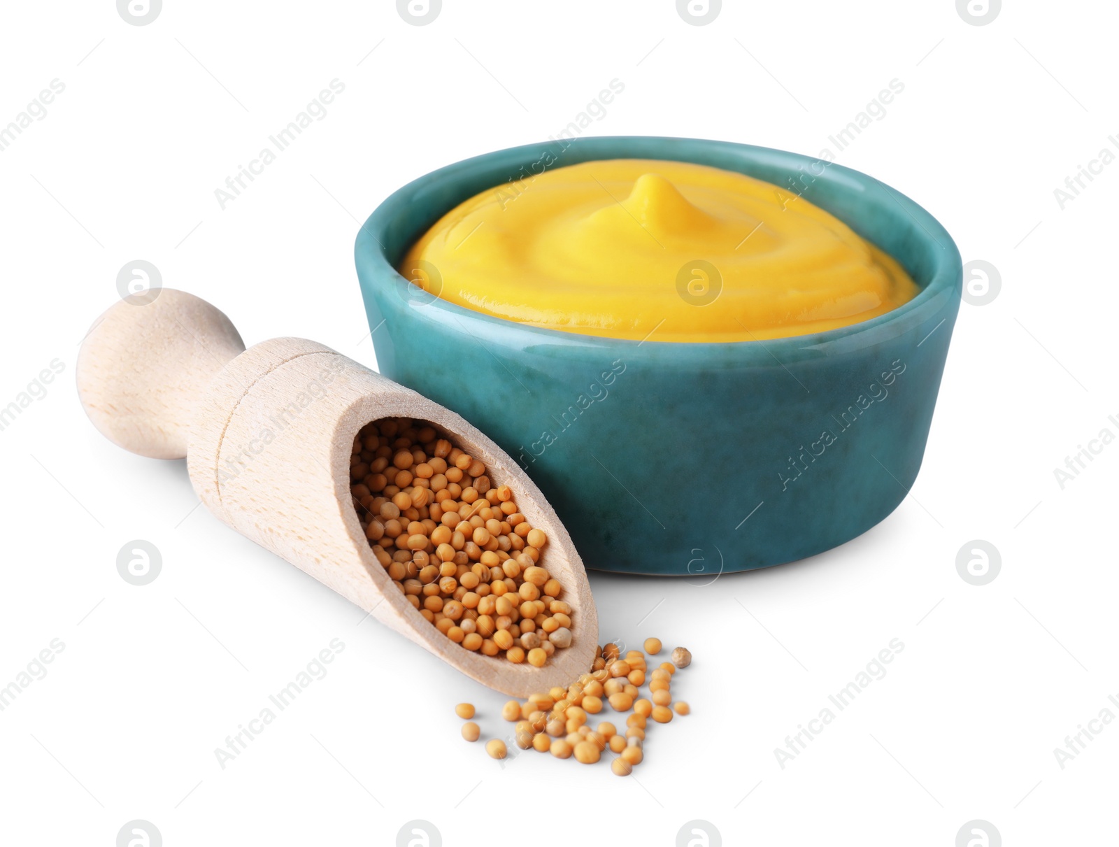 Photo of Bowl of delicious mustard and scoop with seeds on white background