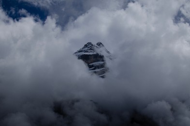 Picturesque view of high mountains covered with fog