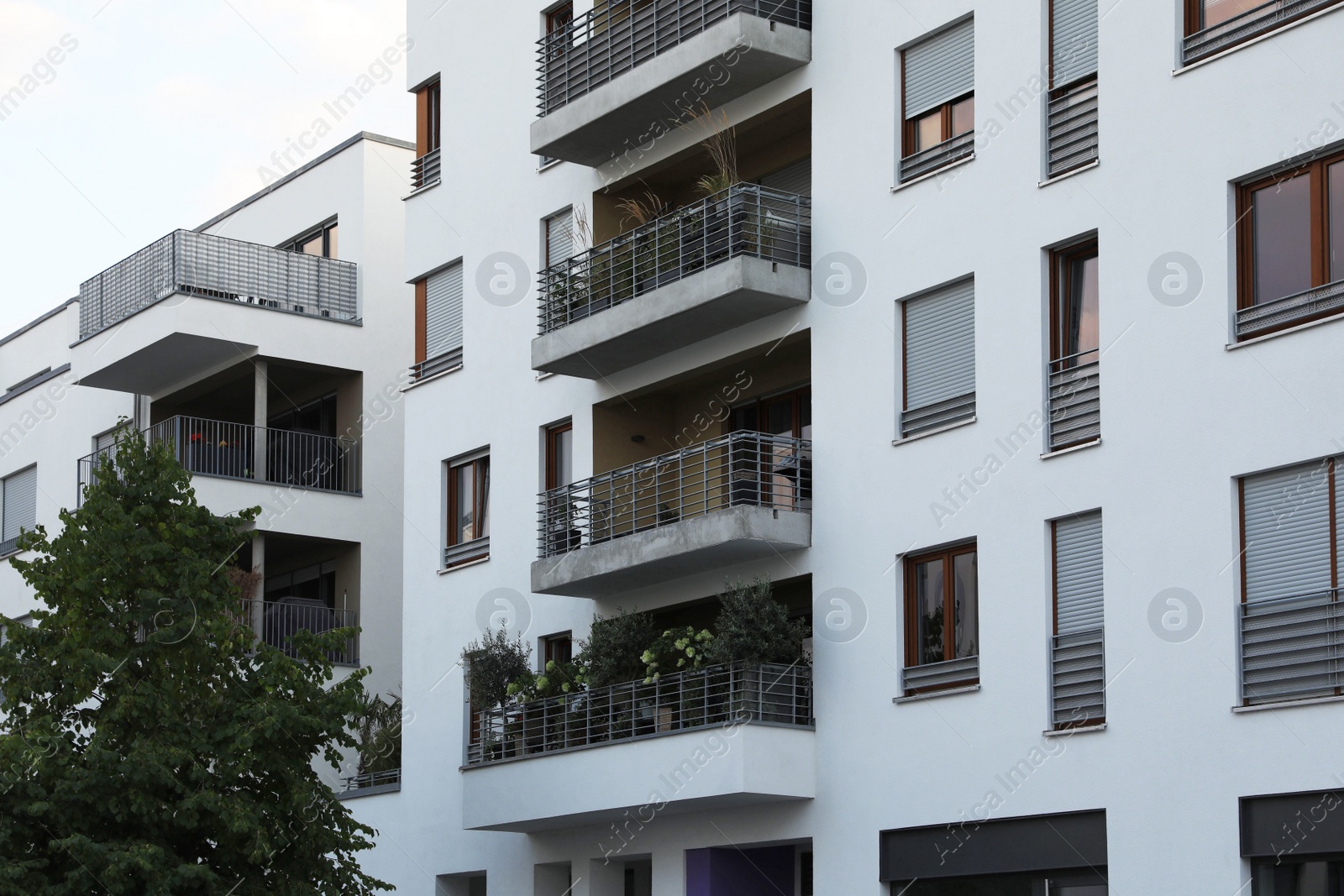 Photo of Beautiful view of modern buildings with big windows outdoors