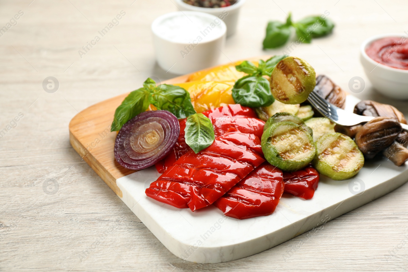 Photo of Delicious grilled vegetables on white wooden table