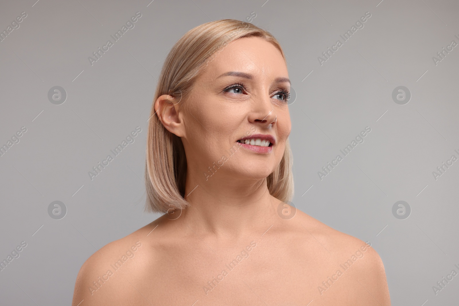 Photo of Beautiful woman with healthy skin on grey background
