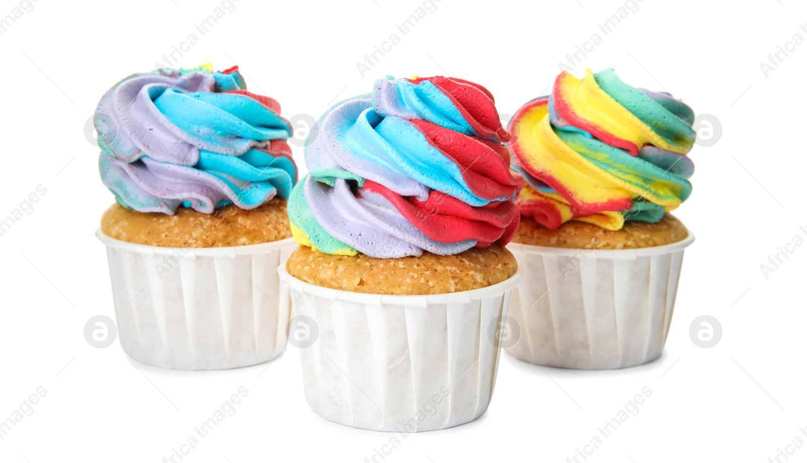 Photo of Three delicious cupcakes with colorful cream on white background