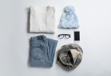 Flat lay composition with female winter clothes on white background