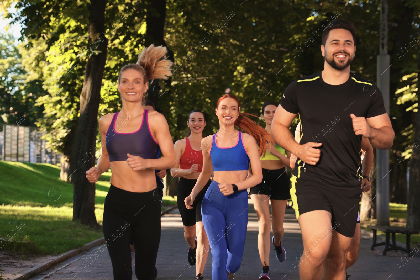 Photo of Group of people running in park. Active lifestyle