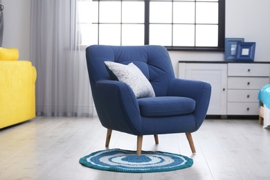 Photo of Stylish room interior with comfortable blue armchair