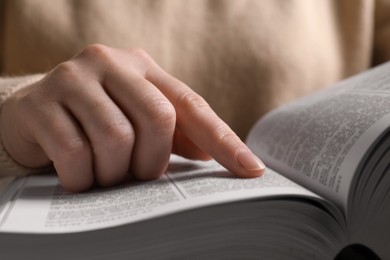 Photo of Woman reading new holy Bible, closeup view