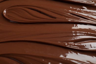 Tasty milk chocolate paste as background, closeup