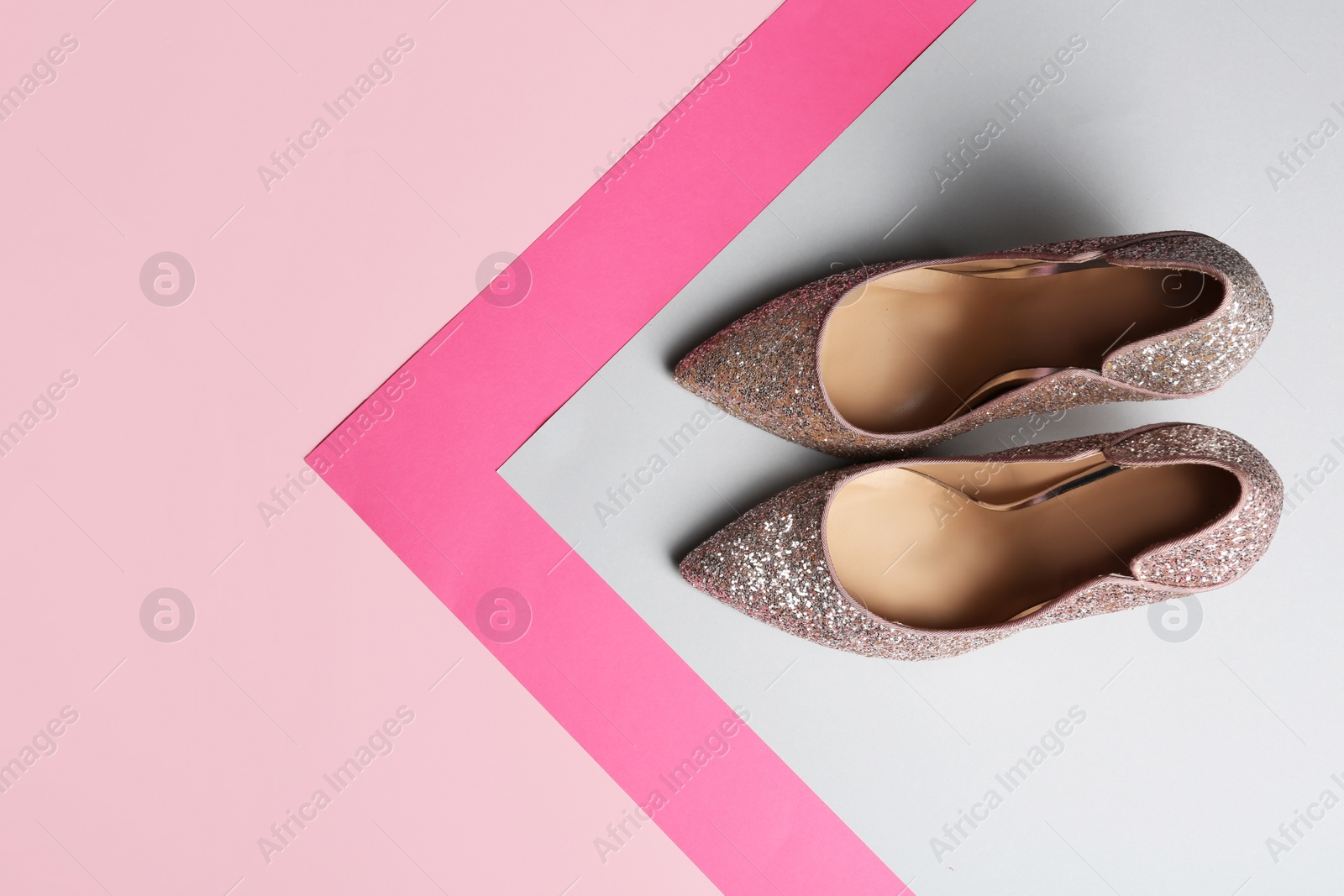 Photo of Stylish high heel shoes on color background, top view. Space for text