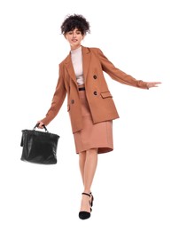 Beautiful businesswoman in suit with briefcase walking on white background