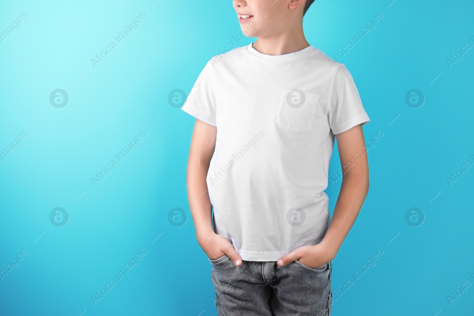 Photo of Little boy in t-shirt on color background. Mock-up for design