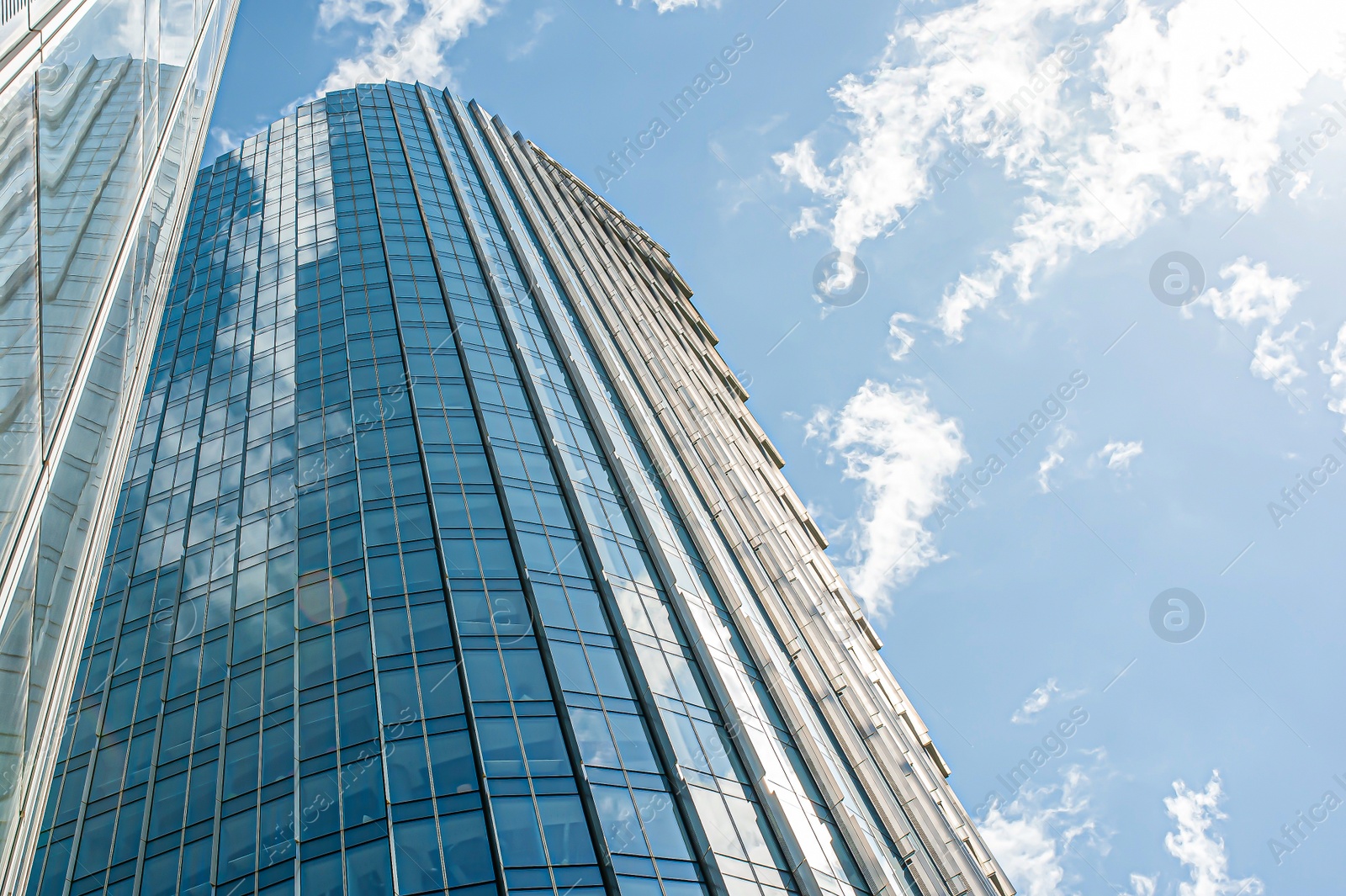 Photo of Beautiful building with many windows under cloudy sky, low angle view