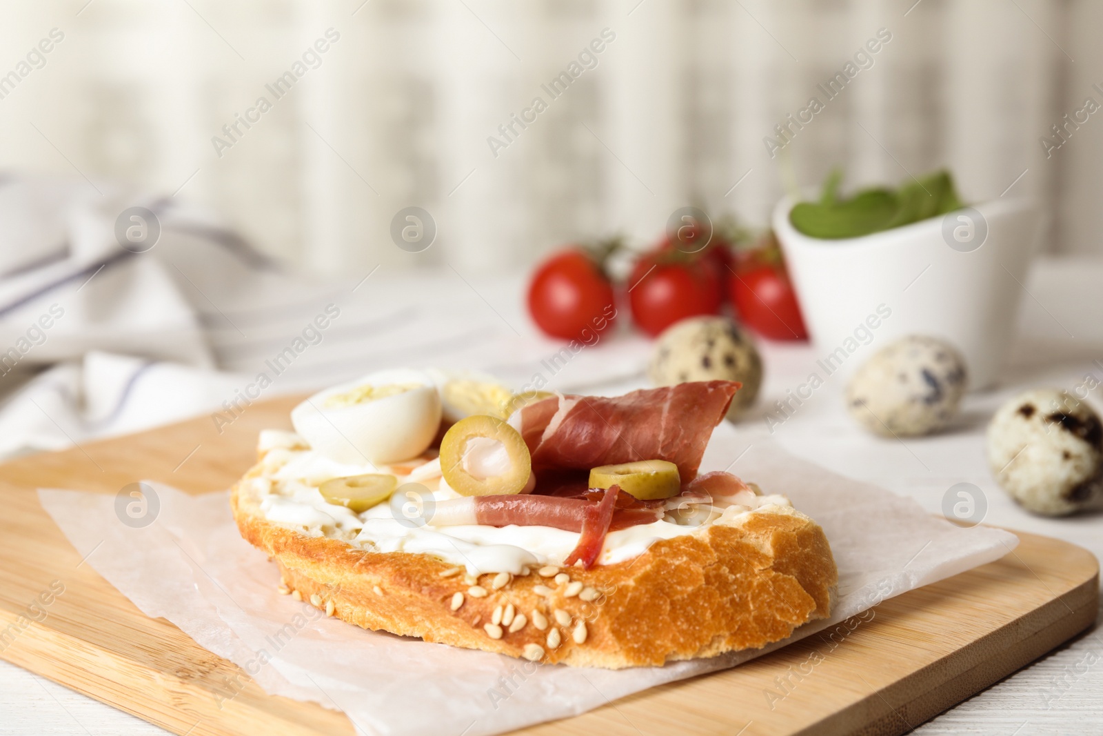 Photo of Cutting board with delicious bruschetta on table