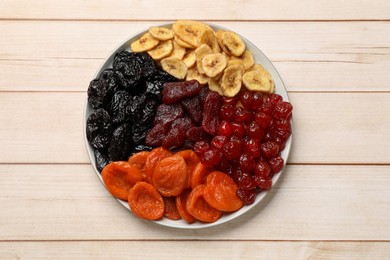 Delicious dried fruits on white wooden table, top view