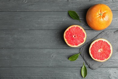 Photo of Flat lay composition with grapefruits and space for text on wooden background