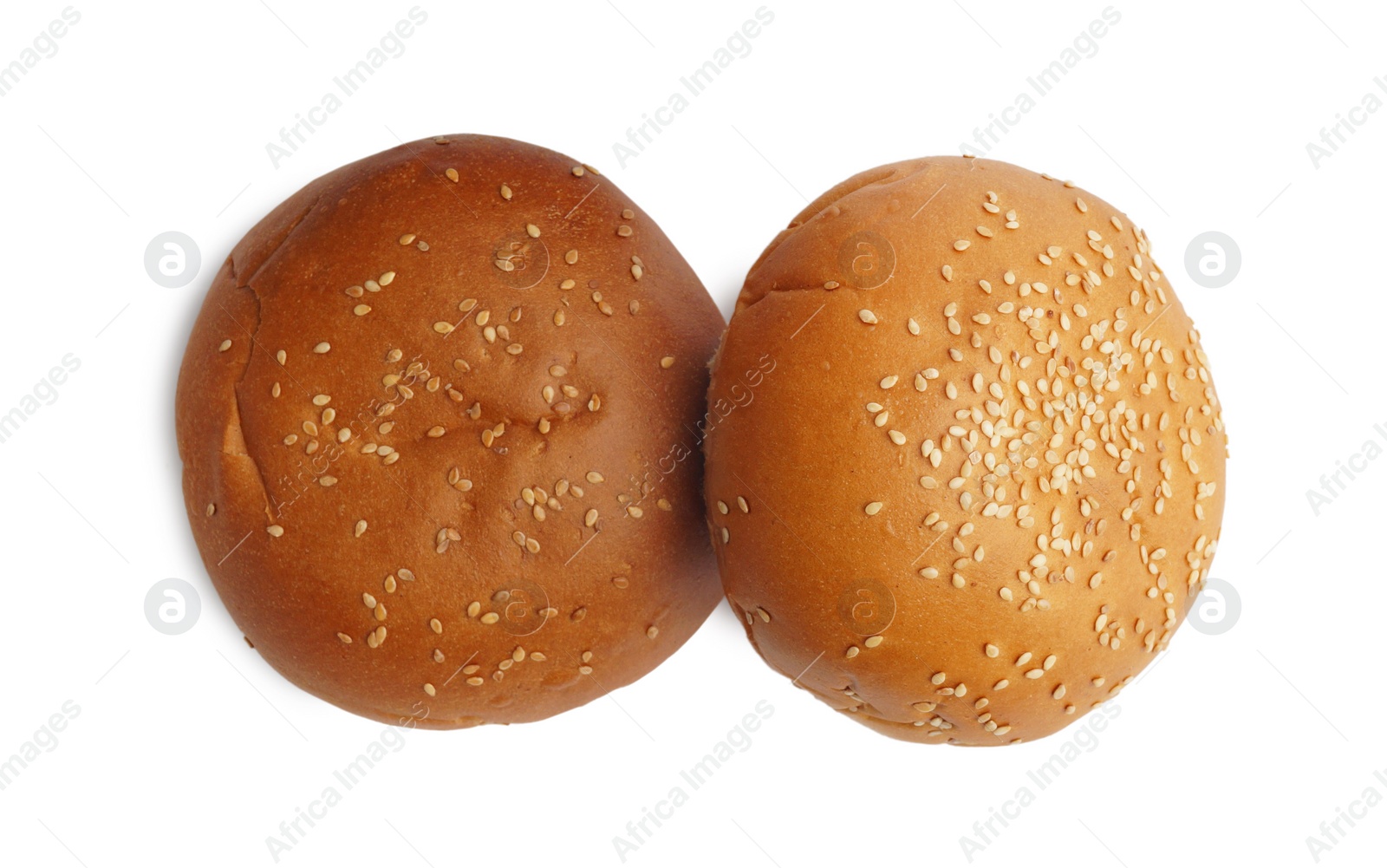 Photo of Fresh tasty buns with sesame seeds isolated on white, top view