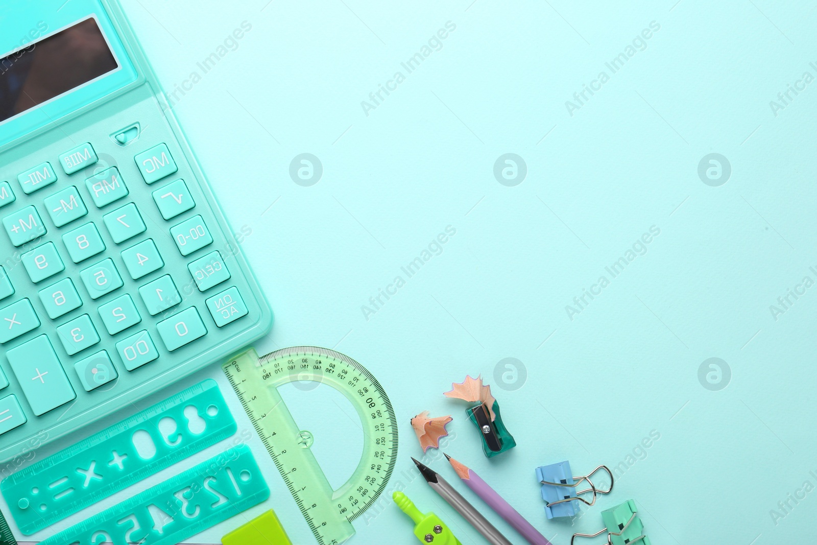 Photo of Calculator and stationery on light background, flat lay. Space for text