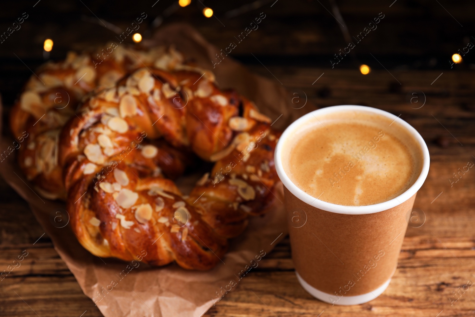 Photo of Delicious coffee and pastries on wooden table