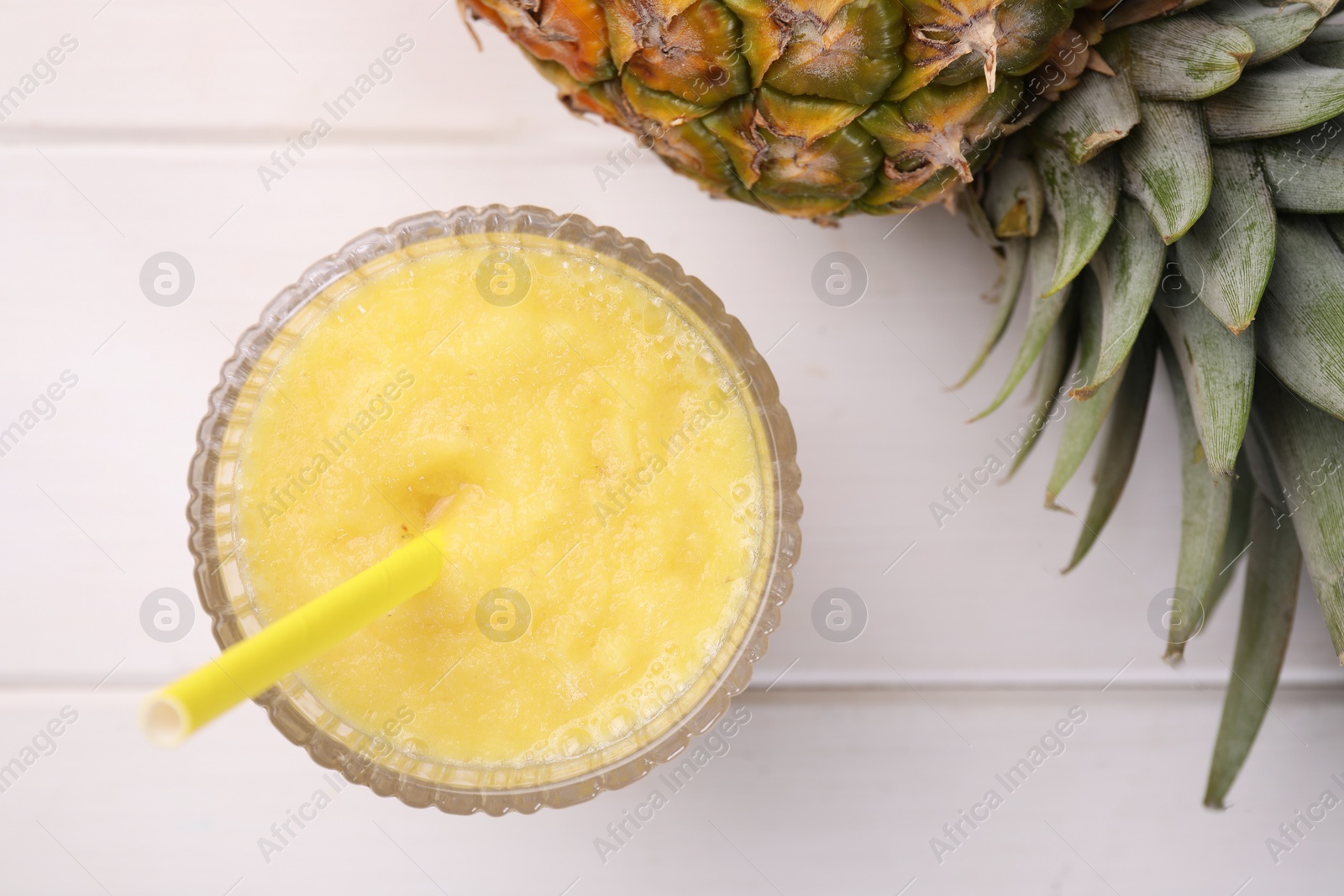 Photo of Tasty pineapple smoothie and fresh fruit on white wooden table, flat lay