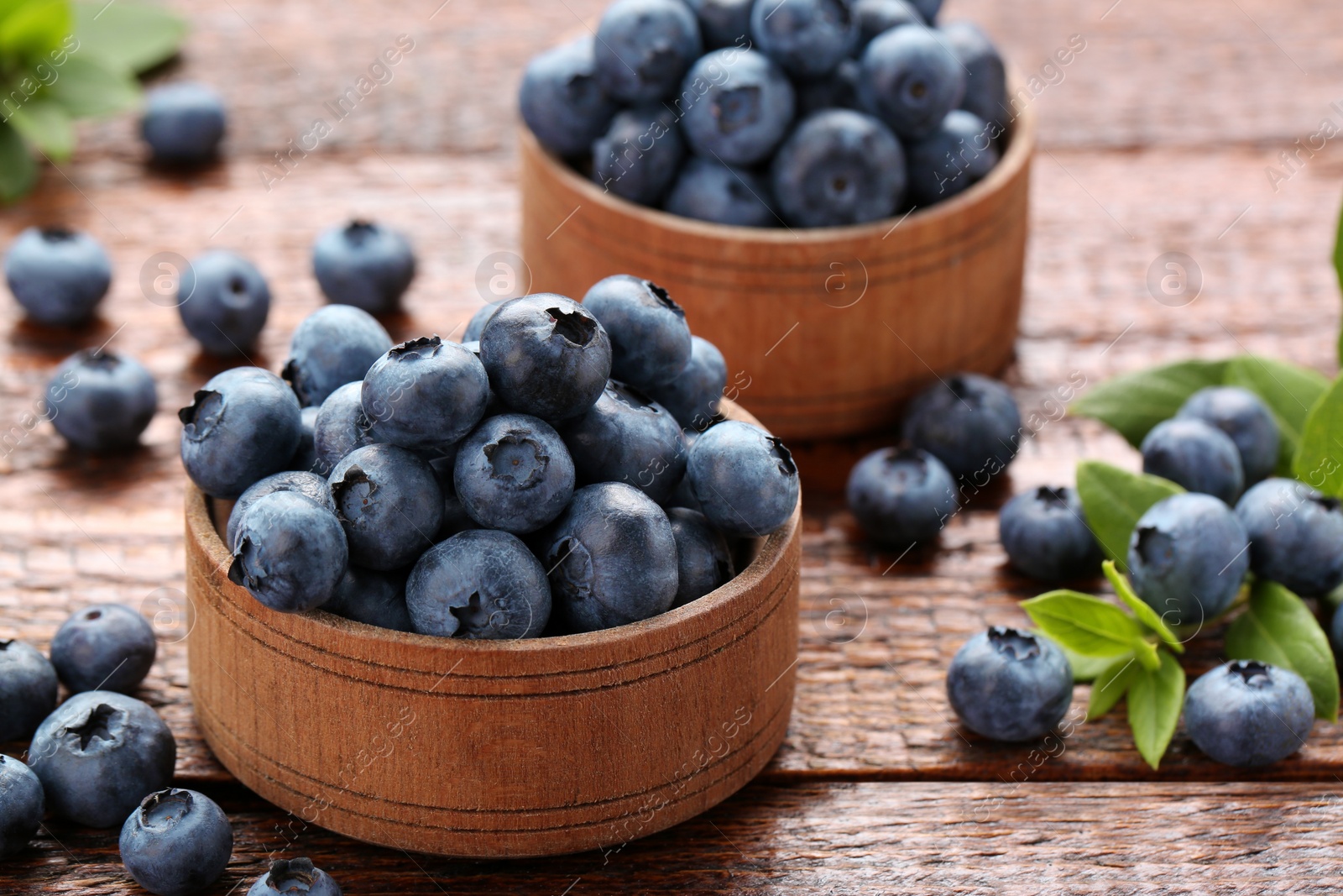 Photo of Tasty fresh blueberries on wooden table, closeup