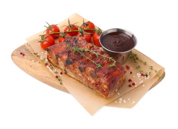 Photo of Tasty roasted pork ribs, thyme, sauce and tomatoes isolated on white