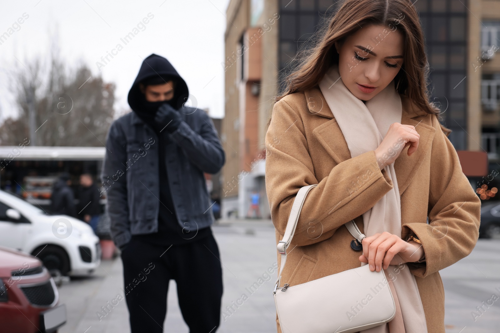 Photo of Man stalking young woman on city street