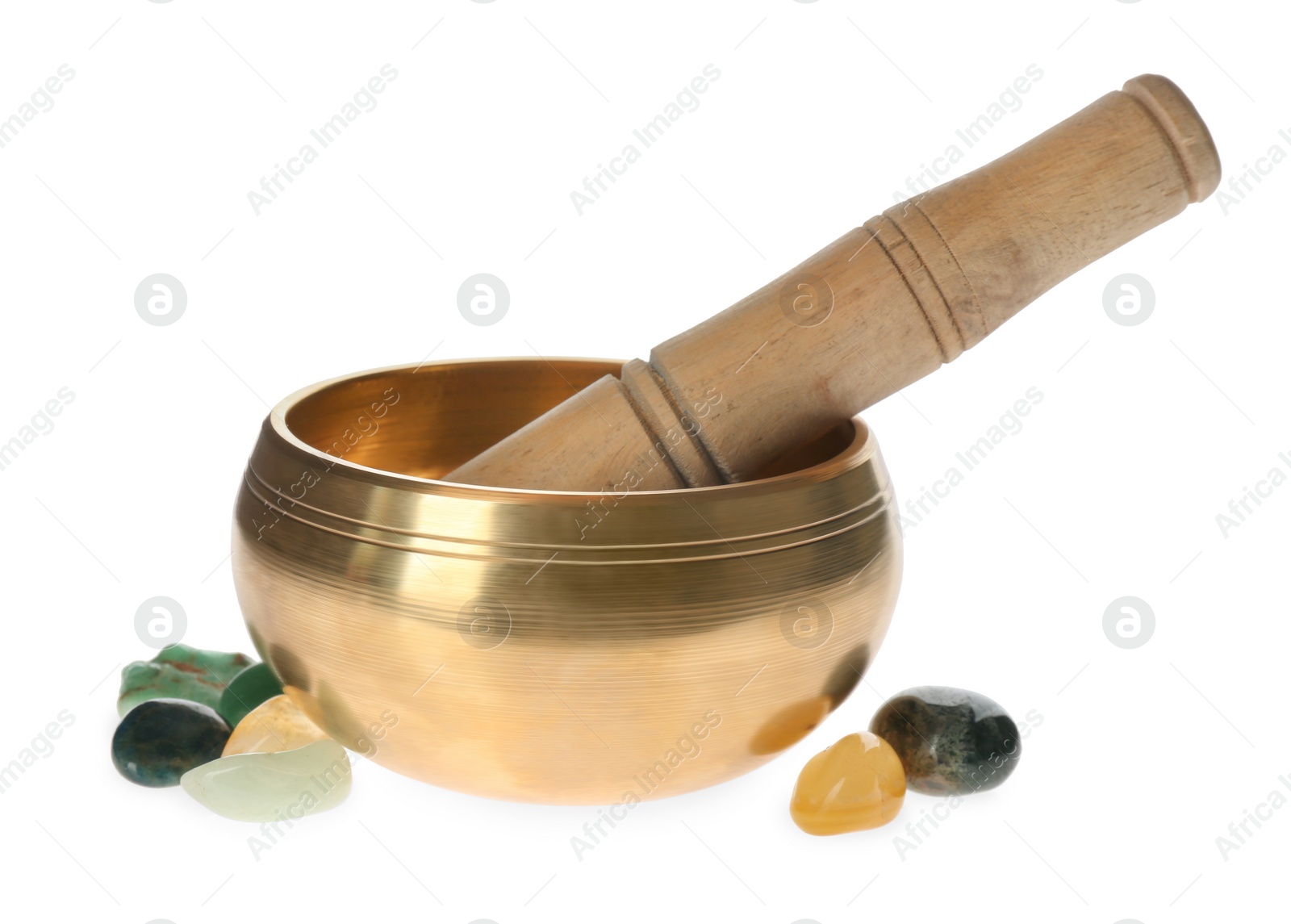 Photo of Golden singing bowl with mallet and healing stones on white background