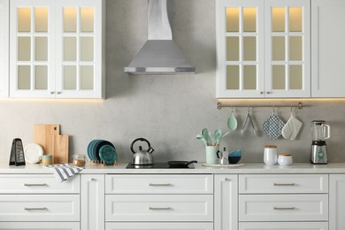 Photo of Set of different utensils and dishes on countertop in kitchen