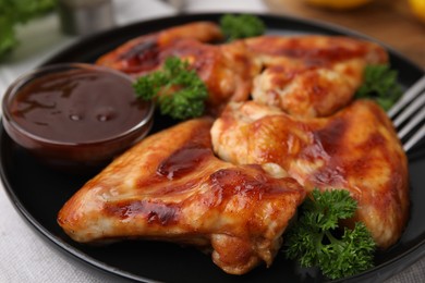 Photo of Fresh marinade and chicken wings on table, closeup