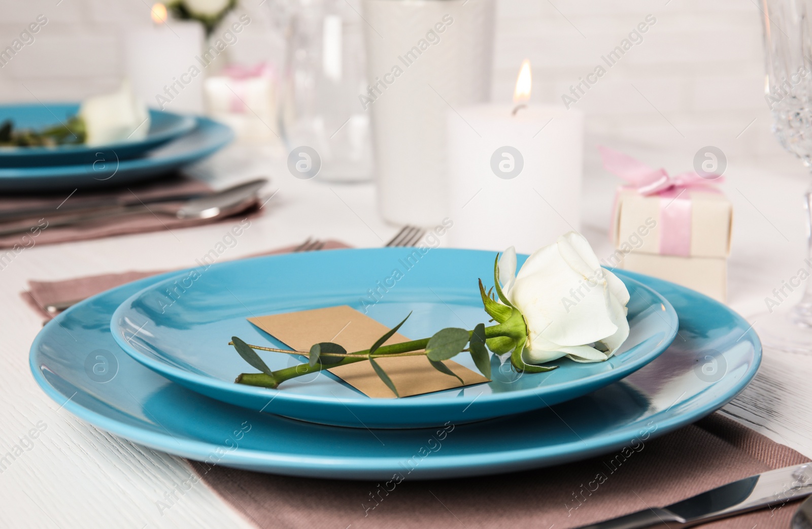 Photo of Elegant festive table setting with blank card in restaurant