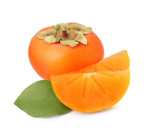 Photo of Whole and cut delicious ripe juicy persimmons with green leaf on white background