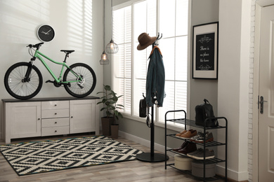 Hallway interior with stylish furniture and green bicycle