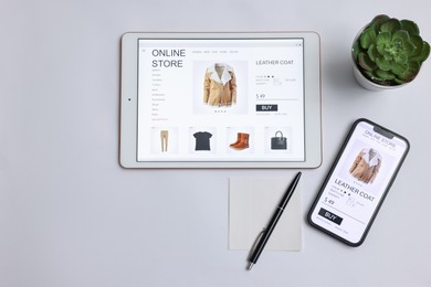 Photo of Online shopping. Flat lay composition with modern tablet and smartphone on white background