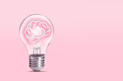 Lamp bulb with human brain inside on pink background, space for text. Idea generation