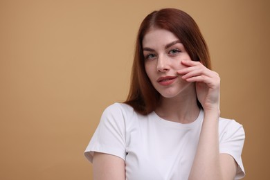 Portrait of beautiful woman on beige background. Space for text