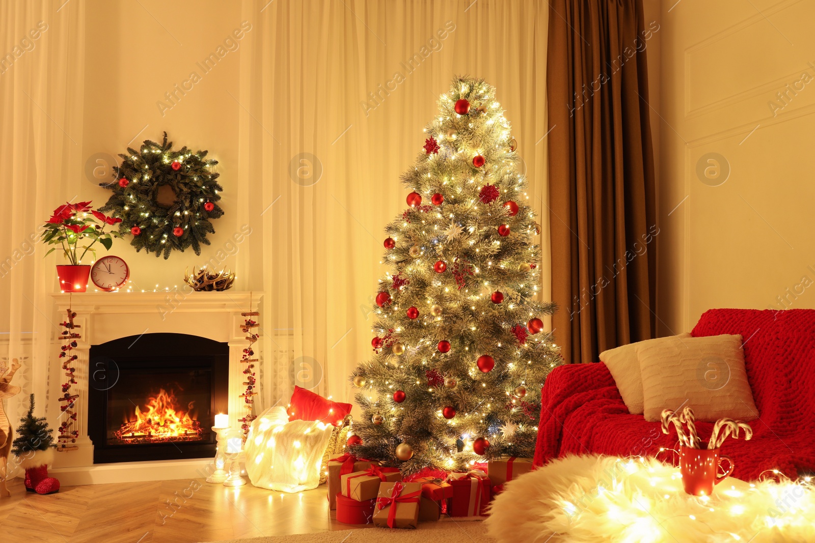 Photo of Beautiful living room interior with burning fireplace and Christmas tree in evening